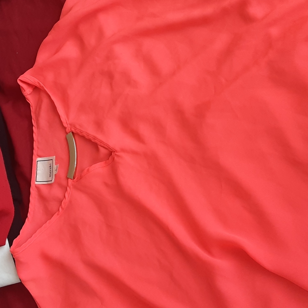 Pink tank top with a gold piece on the collar